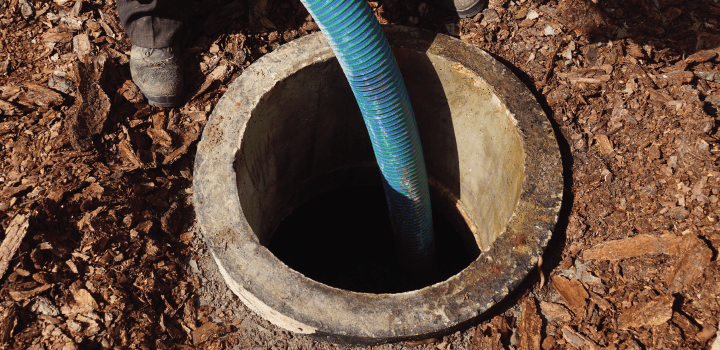 An extendable pump is snaked through a manhole in Ashford.