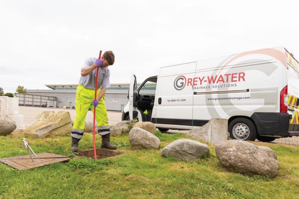 Chris uses a long drain rod to unblock a manhole in Gillingham.