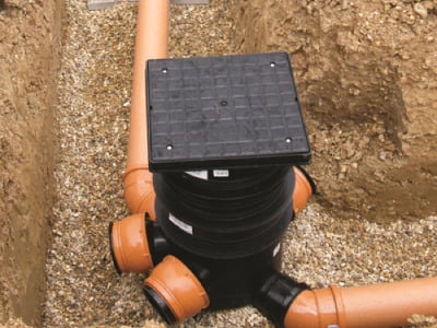 Inspection chamber in an excavated trench.