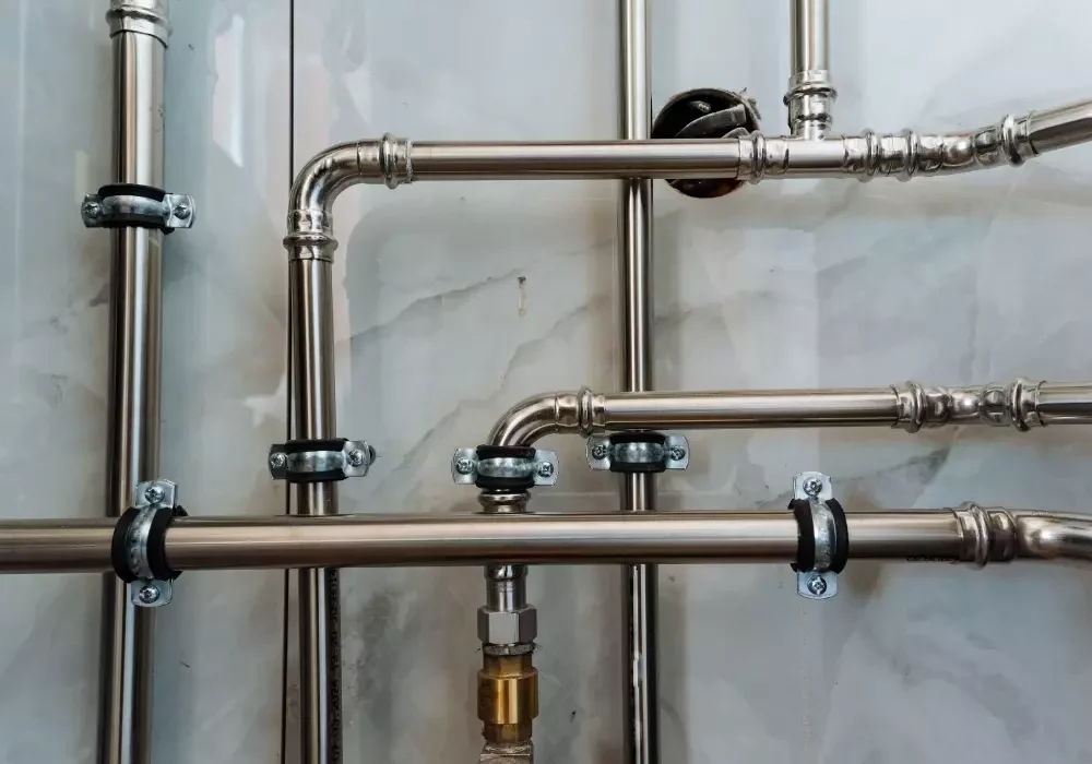 Drain pipes along a wall in a property.