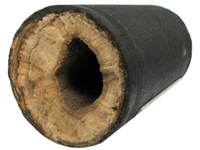 A section of drain pipe coated with a thick layer of scale on the inside.
