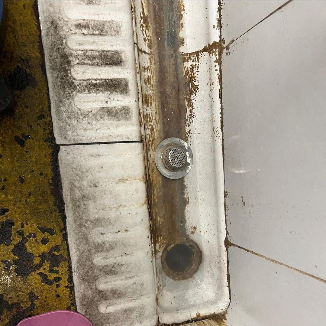 Unblocking a urinal.